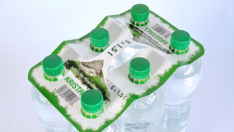 Printed cardboard bottle carrier for six water bottles