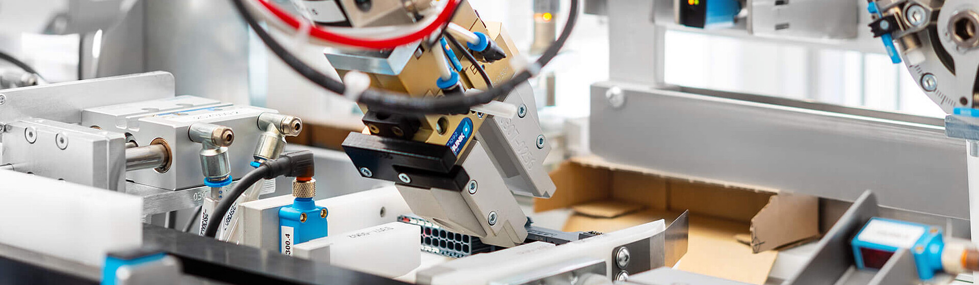 Close-up of a packaging machine with a robot arm