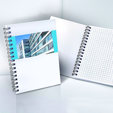 Spiral-bound note pad made from white paper with printed cover
