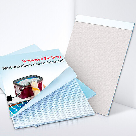 Squared note pad made from white paper with printed cardboard cover sheet