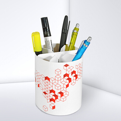 Printed cardboard box in round shape with space for office utensils
