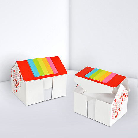 Printed cardboard box in shape of a house, with sheets and markerset