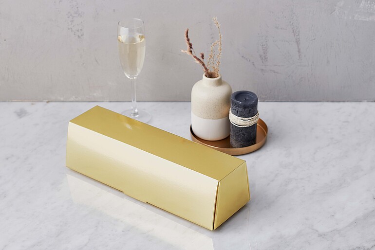 Gold gift packaging in the shape of a gold bar